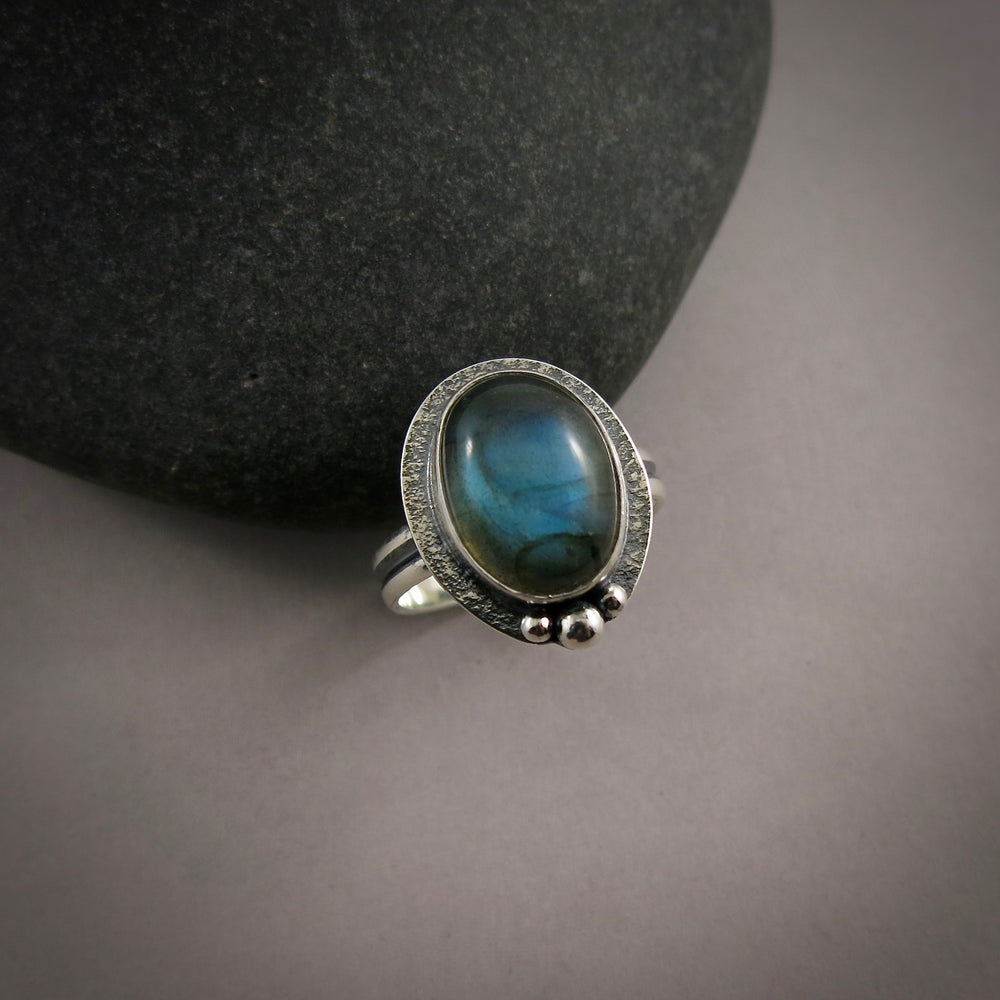 Oval labradorite halo ring in blackened sterling silver by Mikel Grant Jewellery