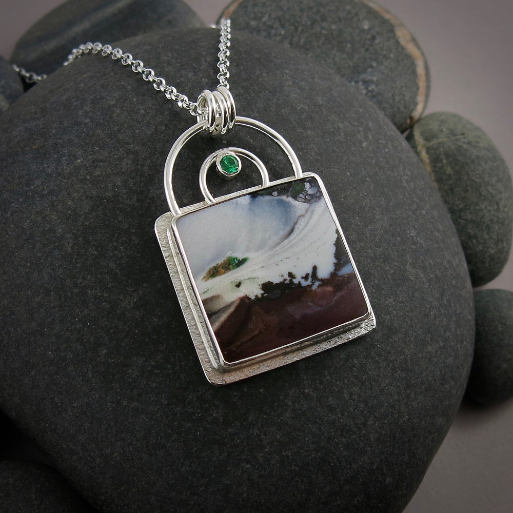 Storm necklace by Mikel Grant Jewellery.  Scenic opalized fossil wood with faceted emerald in sterling silver.