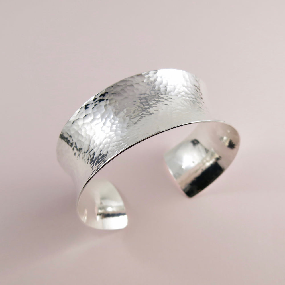 Wide hammer textured silver convex cuff bracelet by Mikel Grant Jewellery