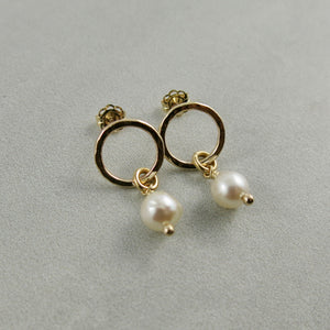 Gold open circle studs with white baroque pearl drops by Mikel Grant Jewellery.