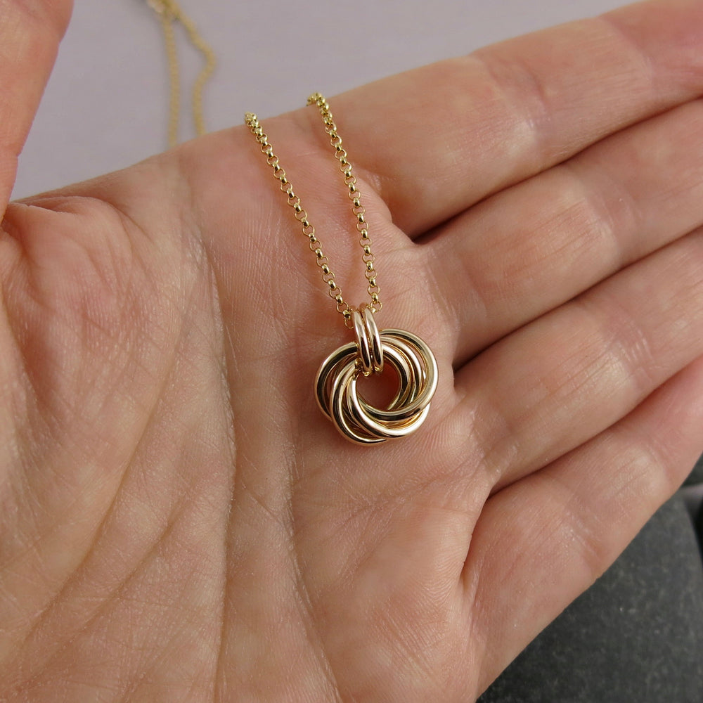 Gold eternity love knot necklace by Mikel Grant Jewellery. Solid 14K gold moveable infinite knot necklace.