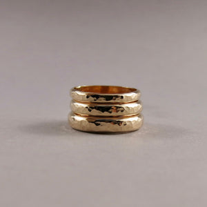 Stack of 14K gold steadfast rings in narrow, medium and wide widths by Mikel Grant Jewellery