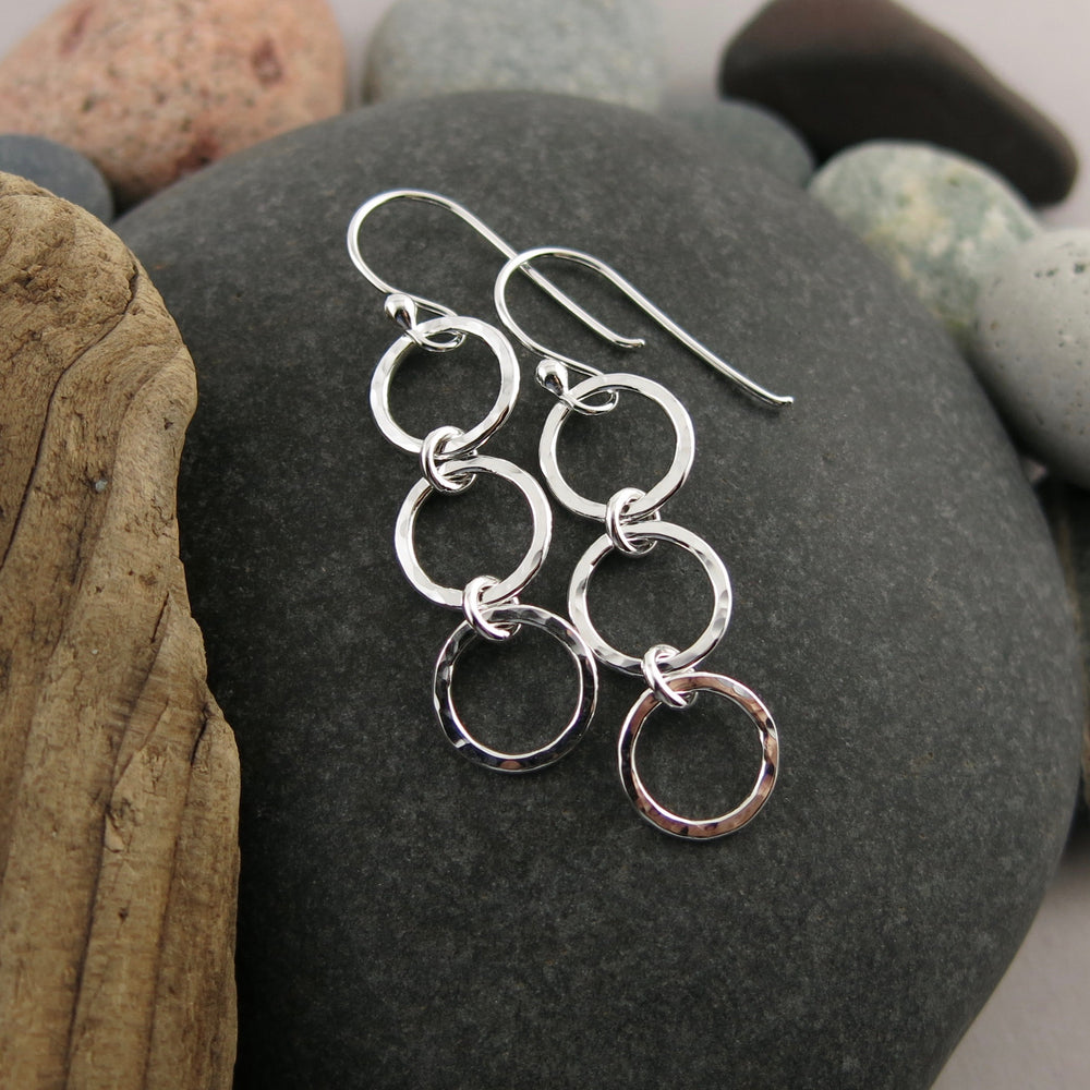 Breathe Trio Drop Earrings: hammer textured sterling silver open circle trio drop earrings by Mikel Grant Jewellery. Artisan made on the Sunshine Coast of BC.