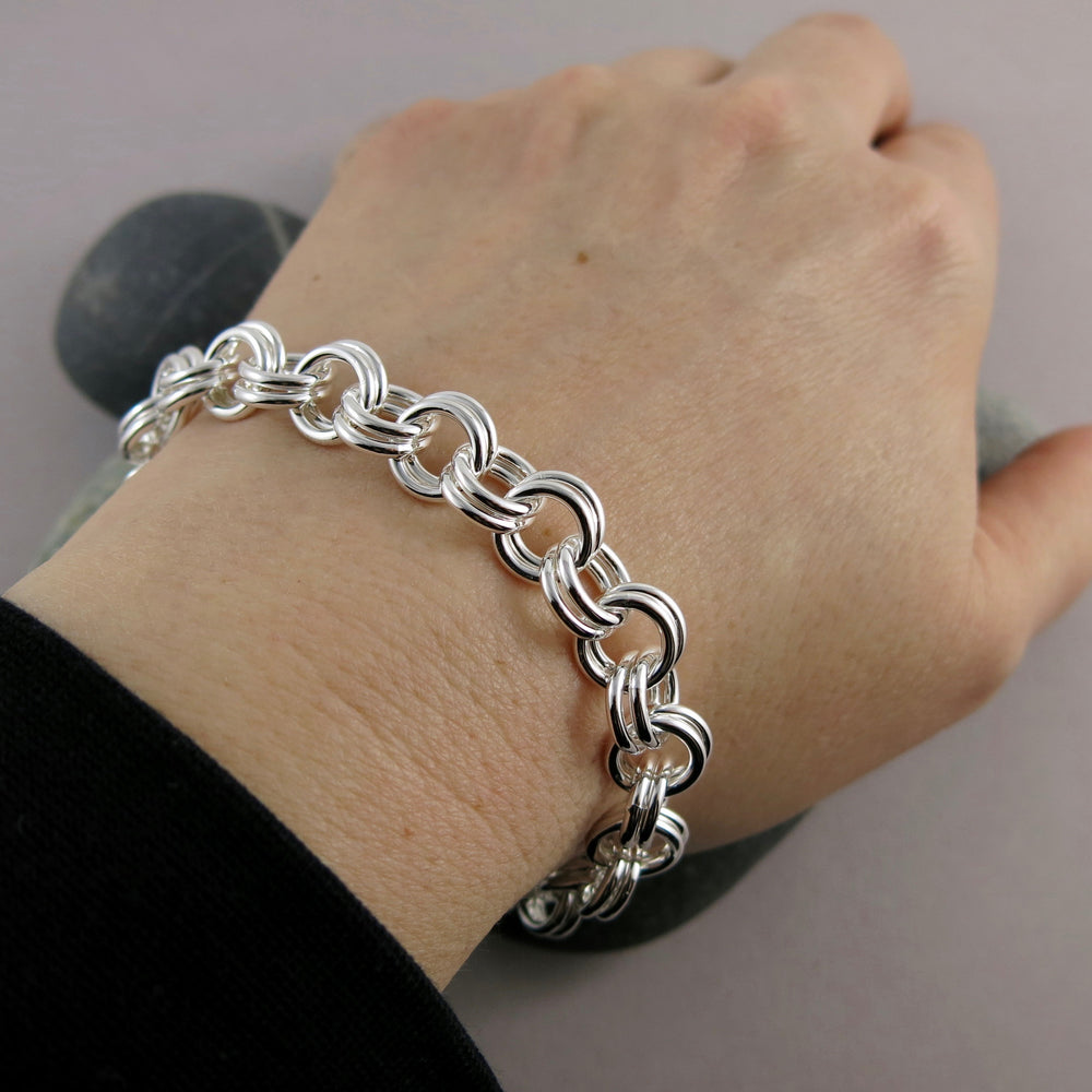 Artisan made heavy double chain link bracelet is silver by Mikel Grant Jewellery. Displayed on an arm.