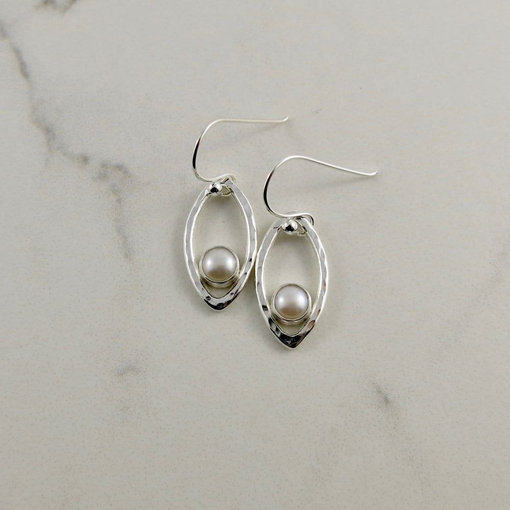 Silver leaf earrings with white button pearls by Mikel Grant Jewellery. Modern minimalist nature inspired earrings