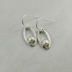 Silver leaf earrings with white button pearls by Mikel Grant Jewellery. Modern minimalist nature inspired earrings