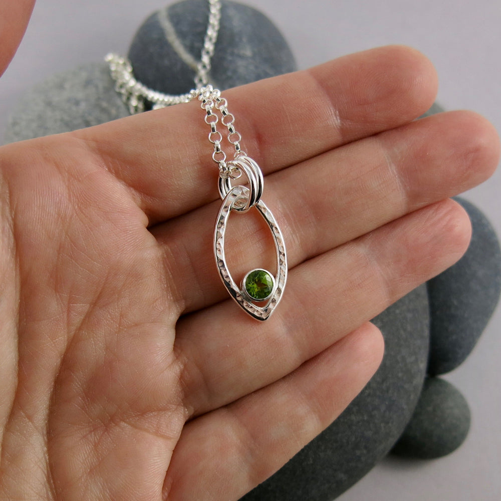 Modern minimalist sterling silver leaf necklace with faceted peridot gemstone by Mikel Grant Jewellery.