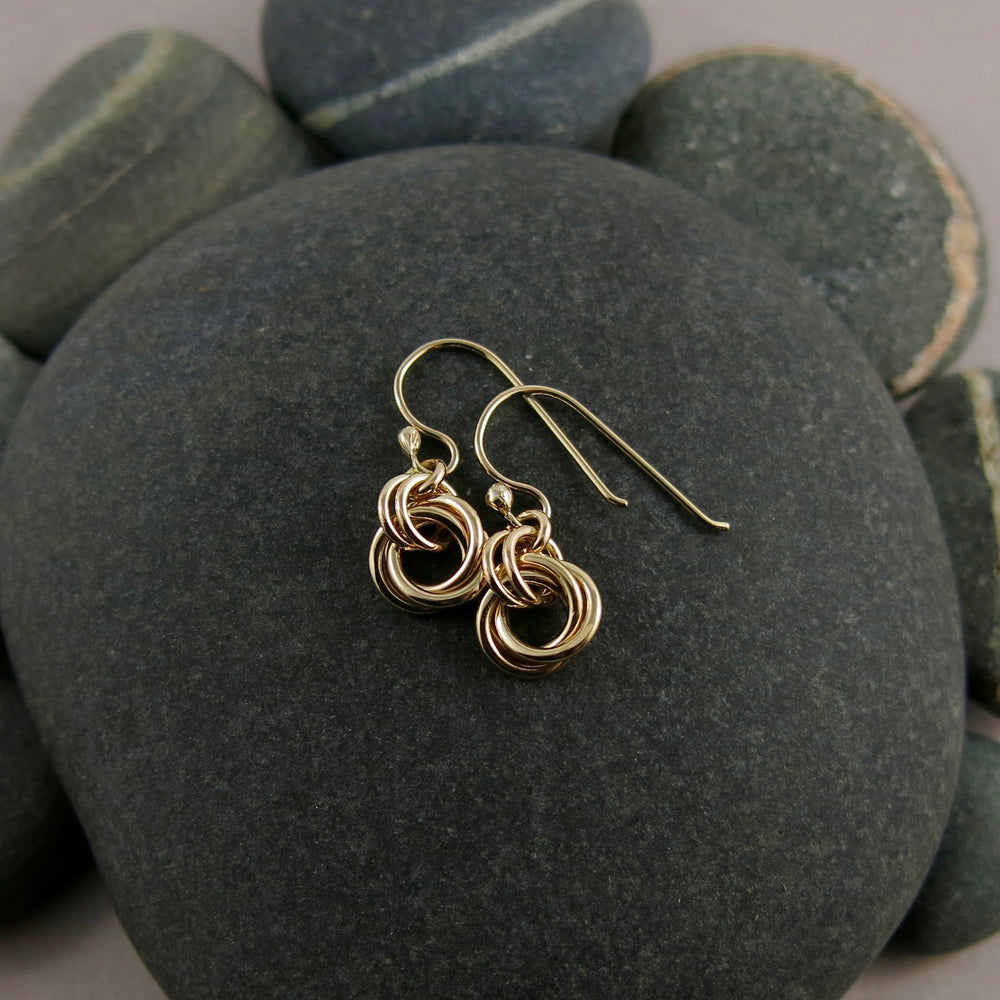 Solid gold love knot earrings by Mikel Grant Jewellery.  Artisan made moveable infinite knot earrings.