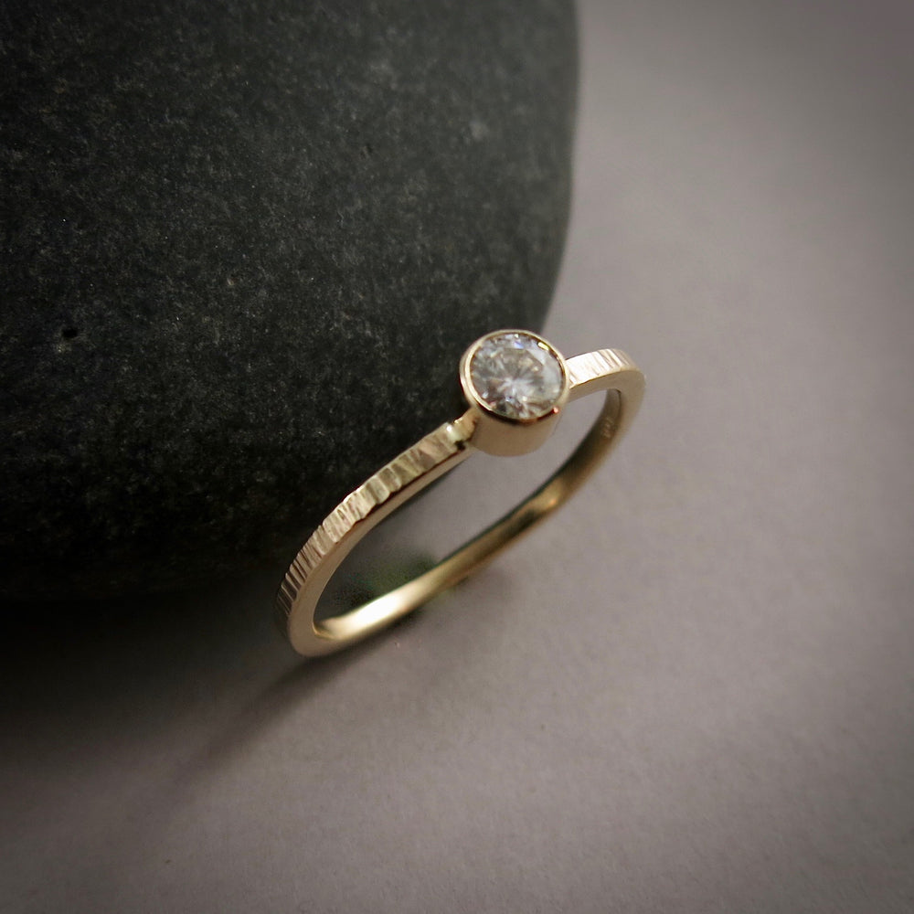 Gold Moissanite Ring by Mikel Grant Jewellery.  Soft square bark textured 14K gold band with bezel-set Moissanite.