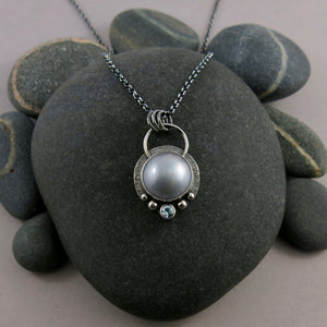 Dove grey mabe pearl necklace with faceted aquamarine in an oxidized sterling silver setting by Mikel Grant Jewellery