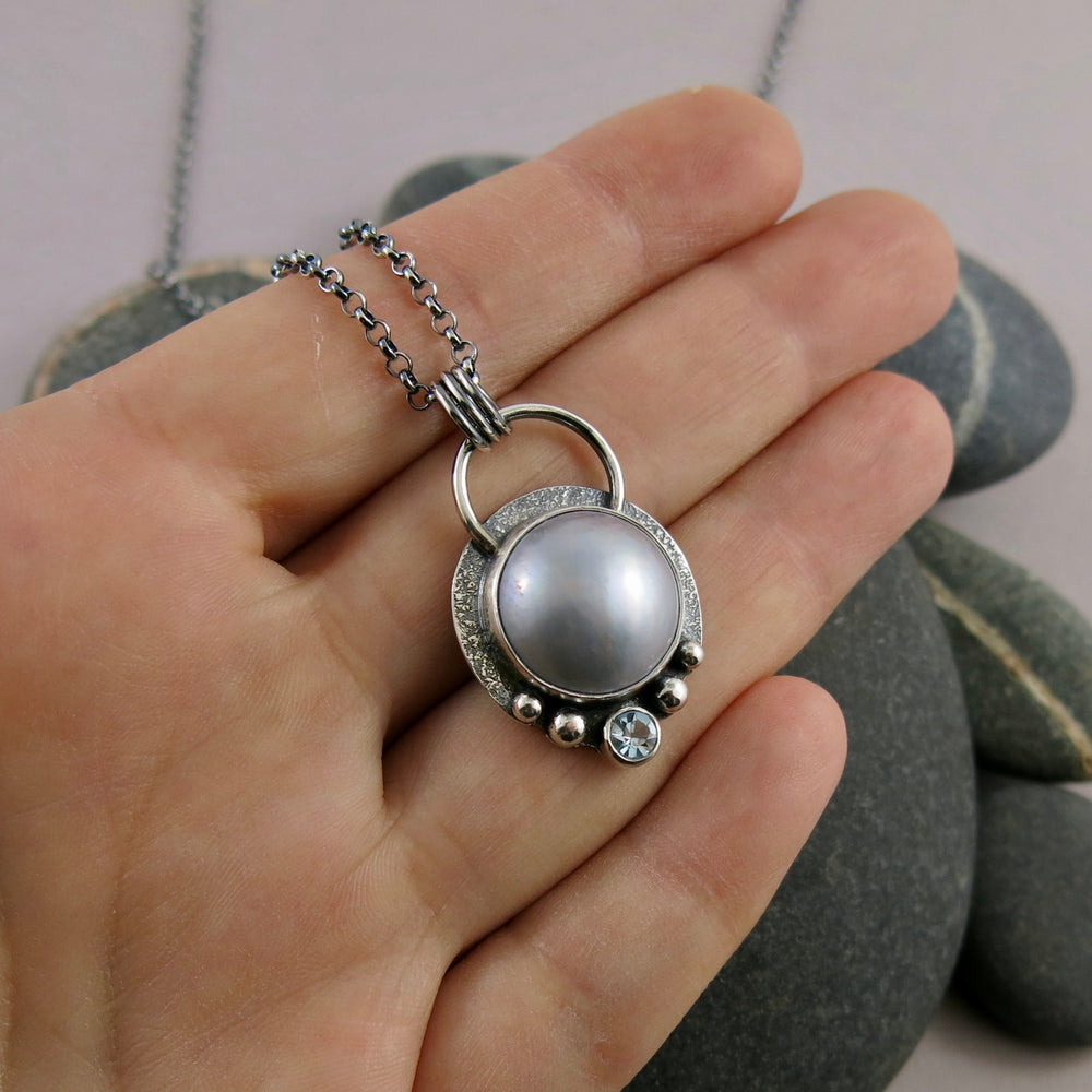 Dove grey mabe pearl necklace with faceted aquamarine in an oxidized sterling silver setting by Mikel Grant Jewellery