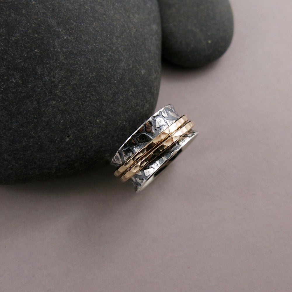 Giraffe print meditation ring on oxidized silver with gold spinning bands by Mikel Grant Jewellery