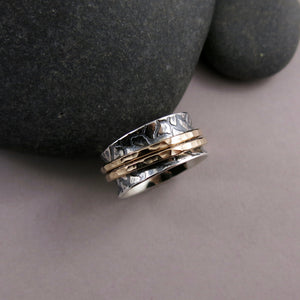 Giraffe print meditation ring on oxidized silver with gold spinning bands by Mikel Grant Jewellery