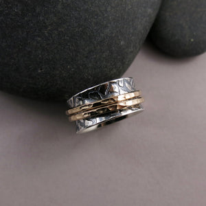 Giraffe print meditation ring on oxidized silver with gold spinning bands by Mikel Grant Jewellery