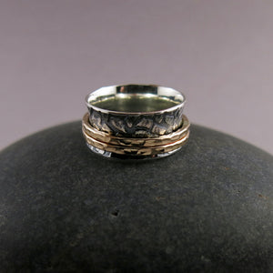 Giraffe print meditation ring on oxidized silver with gold spinning bands by Mikel Grant Jewellery