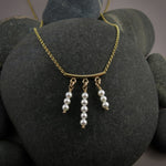 Gold festoon necklace with white akoya pearls by Mikel Grant Jewellery