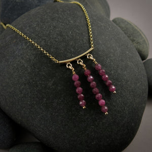 Gold festoon necklace with rubies by Mikel Grant Jewellery.