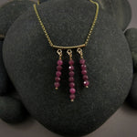 Gold festoon necklace with rubies by Mikel Grant Jewellery.