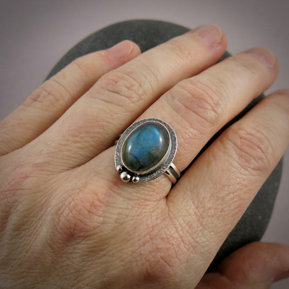 Oval labradorite halo ring in blackened sterling silver by Mikel Grant Jewellery