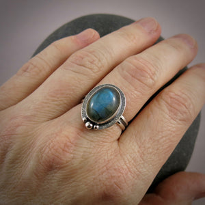 Oval labradorite halo ring in blackened sterling silver by Mikel Grant Jewellery