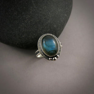 Oval labradorite halo ring in blackened sterling silver by Mikel Grant Jewellery