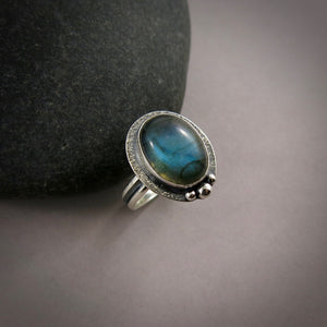 Oval labradorite halo ring in blackened sterling silver by Mikel Grant Jewellery