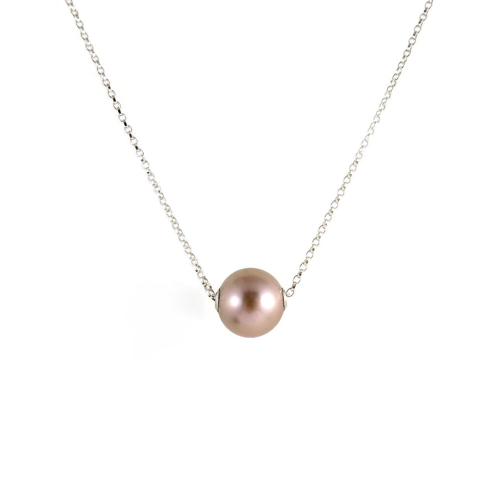 A pearl necklace is displayed on a white background.  The round, lilac-pink pearl is suspended on a sterling silver rolo chain that slides through the centre of the pearl.