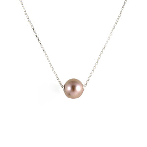 A pearl necklace is displayed on a white background.  The round, lilac-pink pearl is suspended on a sterling silver rolo chain that slides through the centre of the pearl.