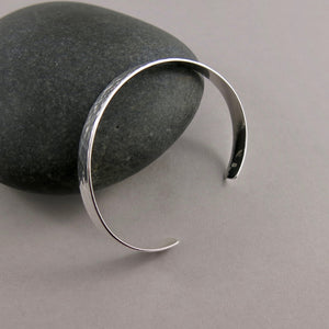 Narrow convex cuff bracelet in hammer textured sterling silver by Mikel Grant Jewellery