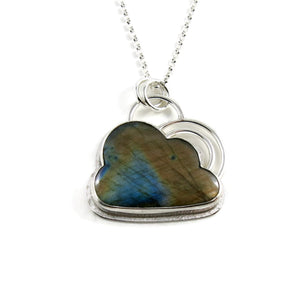 Silver linings necklace by Mikel Grant Jewellery.  An electric blue and orange labradorite gemstone carved into the shape of a cloud is set in a sterling silver setting with a silver "lining" around the piece and a double silver "rainbow" sits above the cloud.  