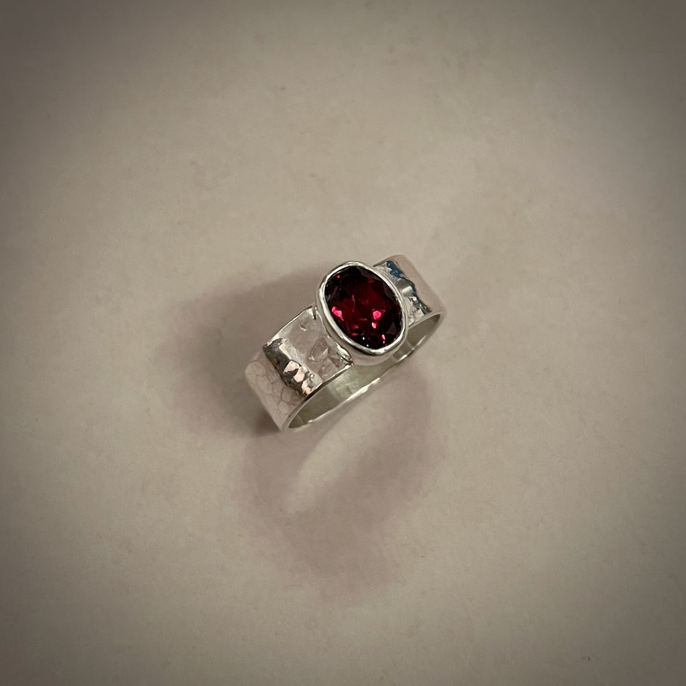 Faceted oval garnet ring on a sterling silver square band ring by Mikel Grant Jewellery