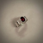 Faceted oval garnet ring on a sterling silver square band ring by Mikel Grant Jewellery