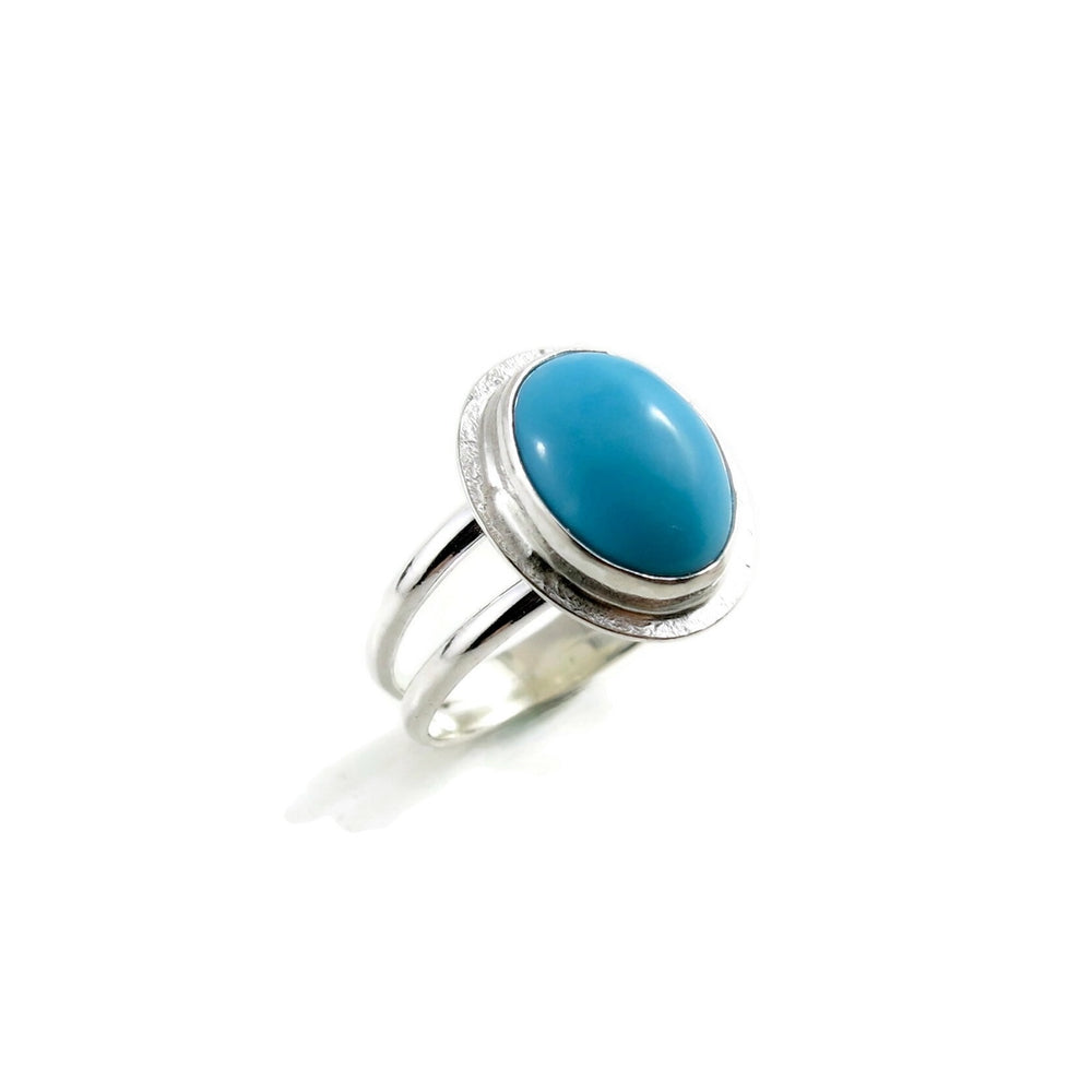 Oval Kingman turquoise halo ring in a sterling silver split-shank ring by Mikel Grant Jewellery.  Size 7.