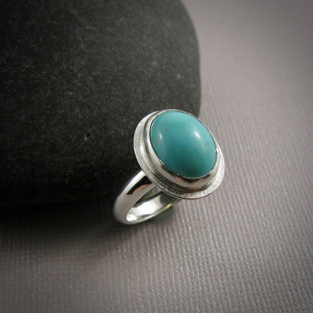 Oval turquoise halo ring in sterling silver by Mikel Grant Jewellery.  Size 9.