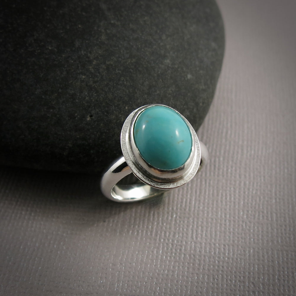 Oval turquoise halo ring in sterling silver by Mikel Grant Jewellery.  Size 9.