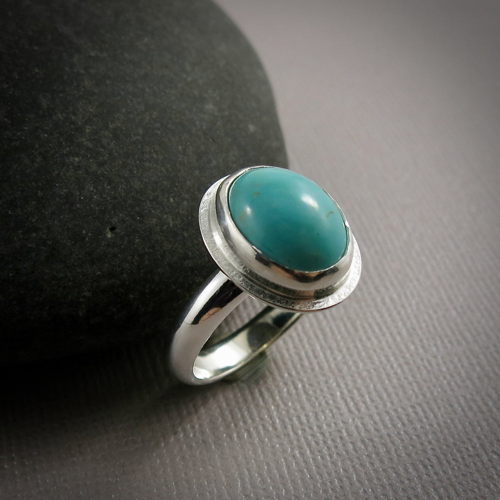 Oval turquoise halo ring in sterling silver by Mikel Grant Jewellery.  Size 9.