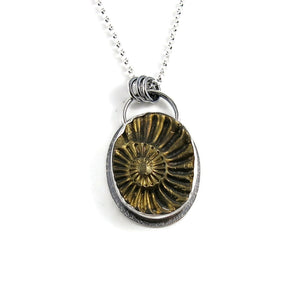 Pyritized ammonite negative fossil necklace in oxidized sterling silver by Mikel Grant Jewellery
