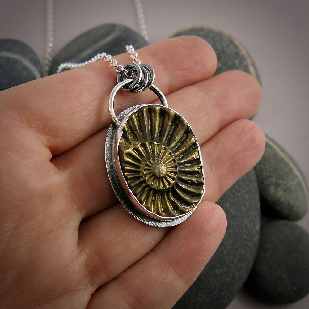 Pyritized ammonite negative fossil necklace in oxidized sterling silver by Mikel Grant Jewellery