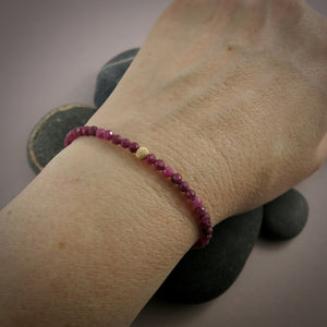 Dainty ruby gemstone bead bracelet with 14K gold filled accents by Mikel Grant Jewellery.