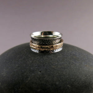 Spirals meditation ring in oxidized sterling silver with gold spinning bands by Mikel Grant Jewellery