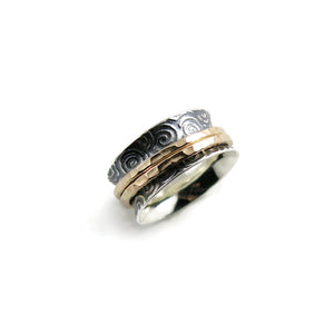 Spirals meditation ring in oxidized sterling silver with gold spinning bands by Mikel Grant Jewellery