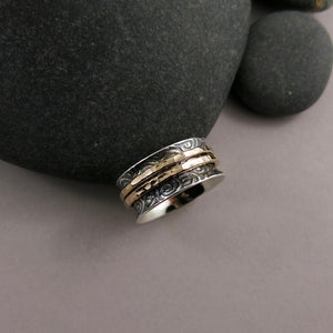 Spirals meditation ring in oxidized sterling silver with gold spinning bands by Mikel Grant Jewellery