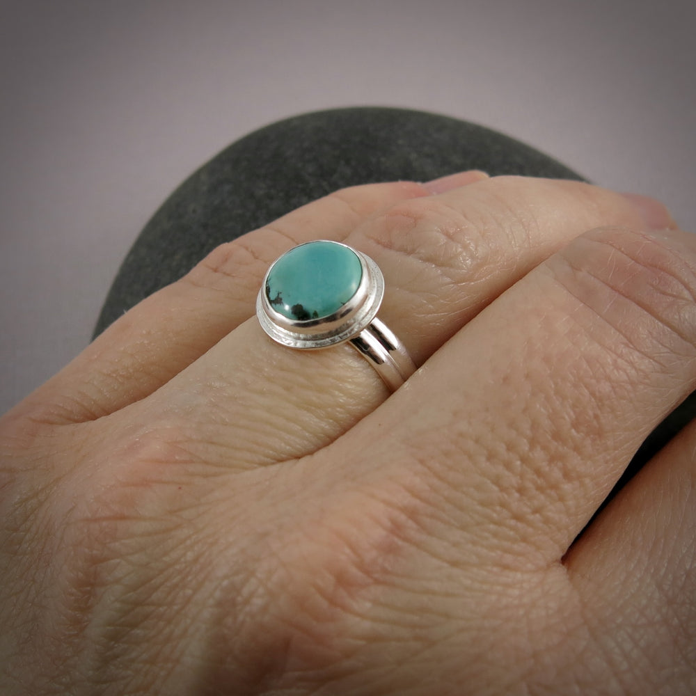 Tibetan turquoise halo ring in sterling silver by Mikel Grant Jewellery.  Size 7.