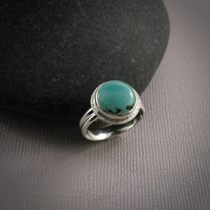 Tibetan turquoise halo ring in sterling silver by Mikel Grant Jewellery.  Size 7.