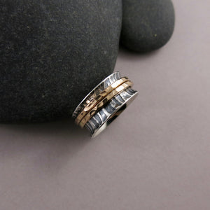 Tiger print meditation ring on oxidized silver with gold spinning bands by Mikel Grant Jewellery