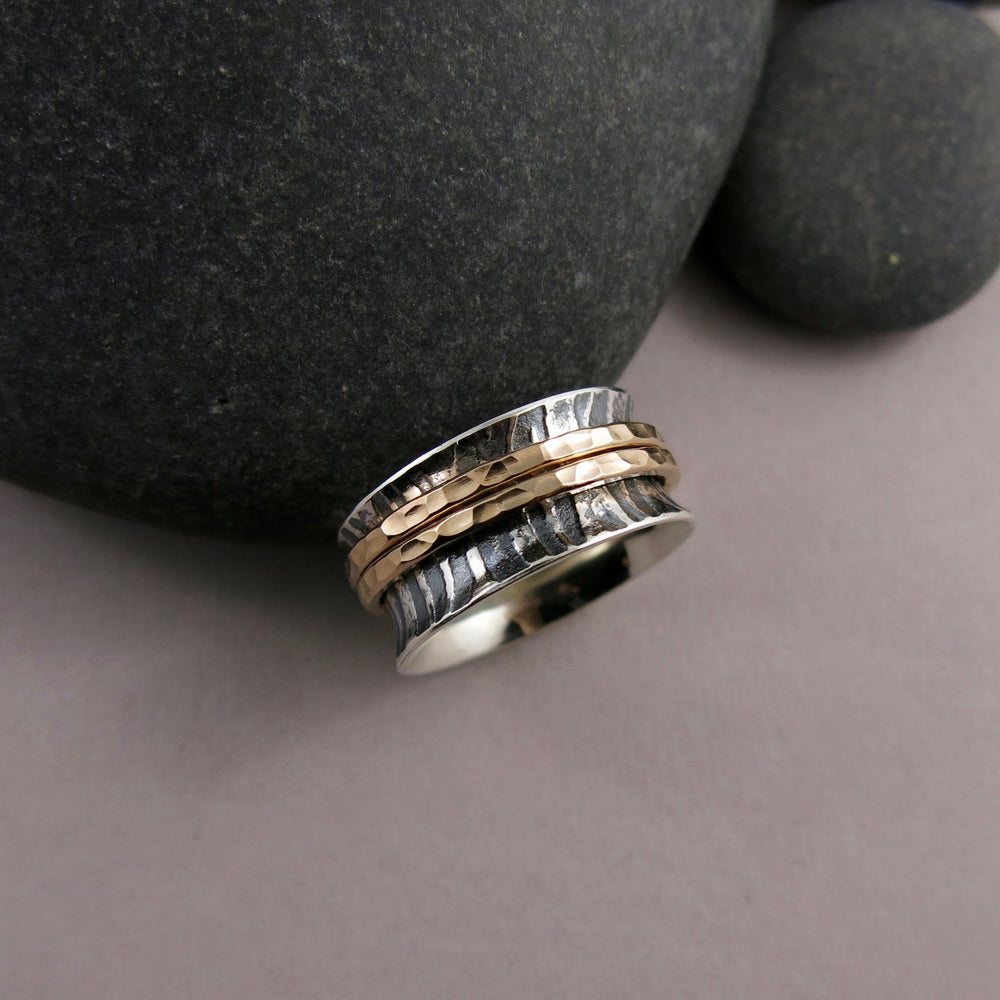 Tiger print meditation ring on oxidized silver with gold spinning bands by Mikel Grant Jewellery