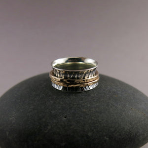 Tiger print meditation ring on oxidized silver with gold spinning bands by Mikel Grant Jewellery