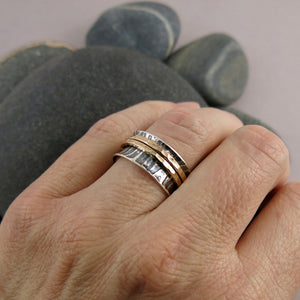 Tiger print meditation ring on oxidized silver with gold spinning bands by Mikel Grant Jewellery