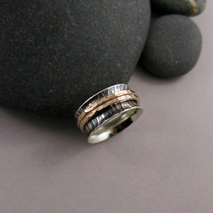 Tiger print meditation ring on oxidized silver with gold spinning bands by Mikel Grant Jewellery