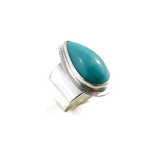 Turquoise talon on a wide silver saddle ring band by Mikel Grant Jewellery.  Size 7.5